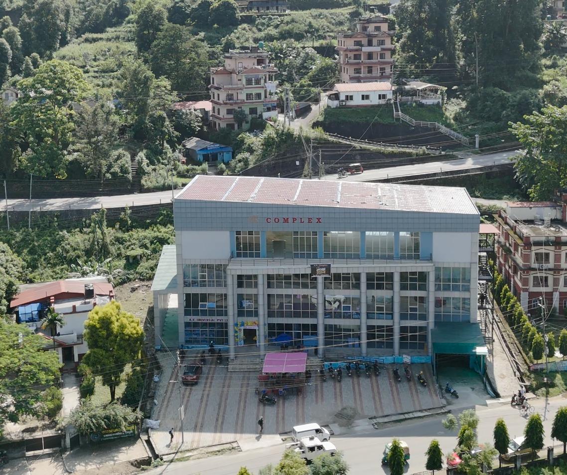 Front of A.K. Complex, a glass-fronted commercial building with an open forecourt
